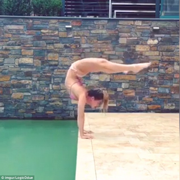 Girl doing split handstand naked