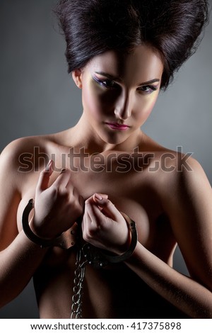 Woman handcuffed nude