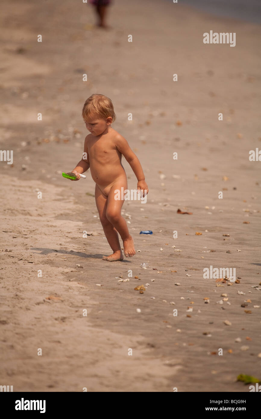 Nude girls playing in ocean beach
