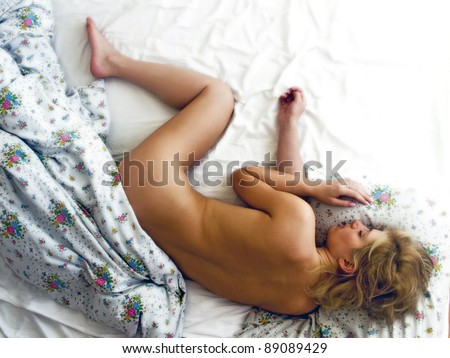 Nude blonde girl sleeping naked